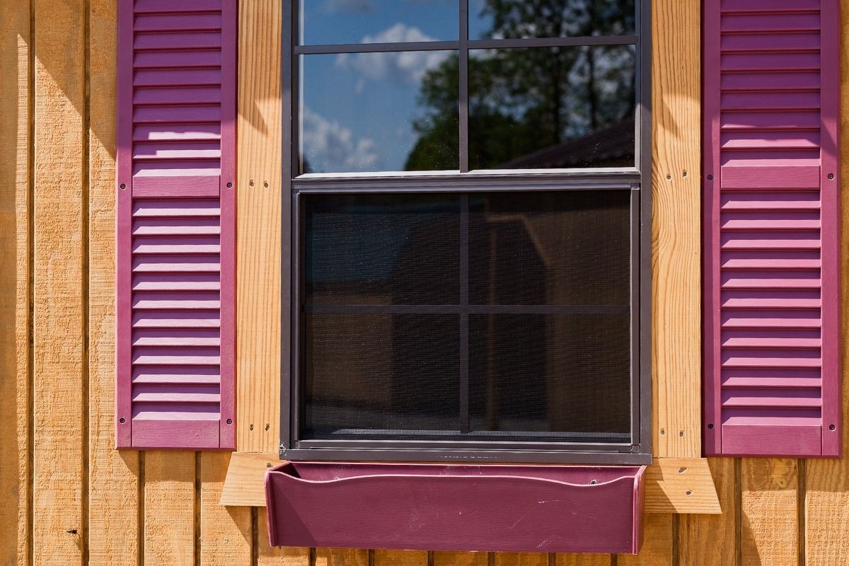 Barn shed window with shutters and flower box